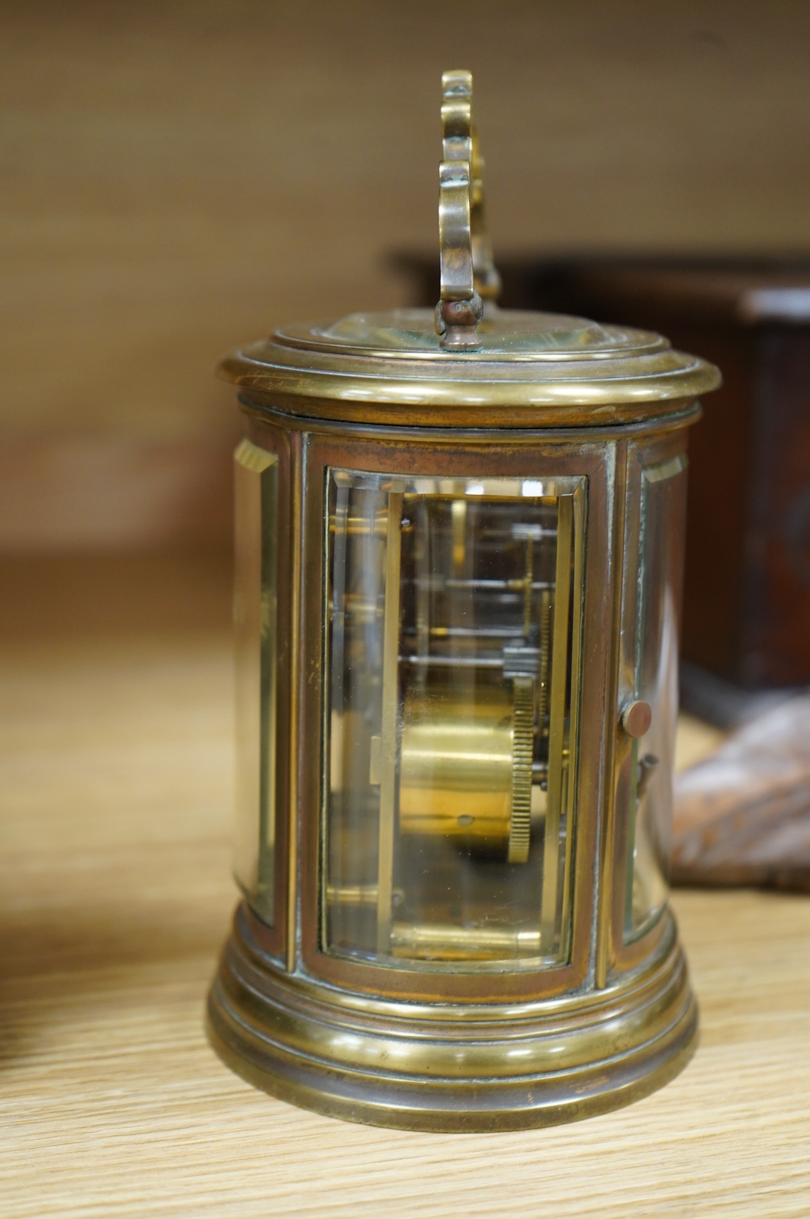 A 19th century oval brass carriage clock, striking on a bell, together with a mahogany and burr yew mantel clock, striking on a coiled gong, gong missing, largest 34cm high